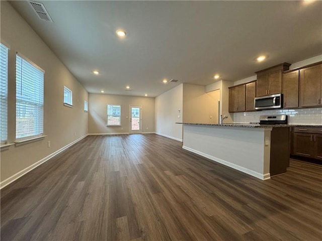 2277 Whitworth St, Lawrenceville, GA 30044 - kitchen featuring stainless steel appliances, dark wood-style flooring, tasteful backsplash, baseboards, and open floor plan