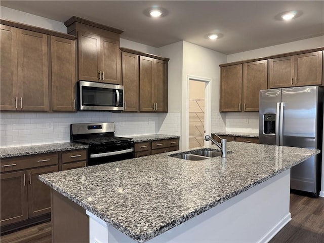 2277 Whitworth St, Lawrenceville, GA 30044 - kitchen with appliances with stainless steel finishes, a sink, dark wood-style flooring, dark stone counters, and recessed lighting