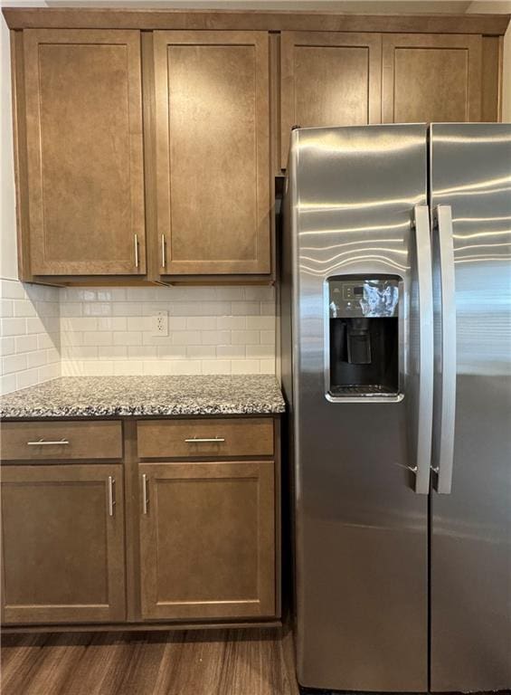2277 Whitworth St, Lawrenceville, GA 30044 - kitchen featuring stainless steel fridge with ice dispenser, dark wood-style floors, light stone counters, and tasteful backsplash