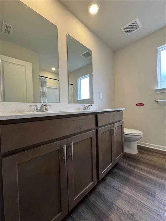 2277 Whitworth St, Lawrenceville, GA 30044 - bathroom with wood finished floors, vanity, toilet, baseboards, and curtained shower