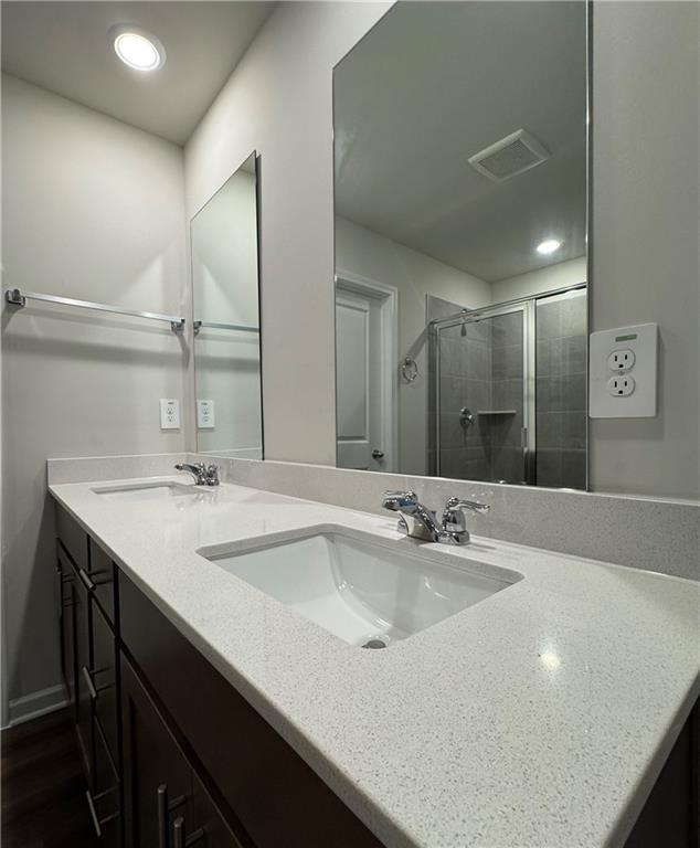 2277 Whitworth St, Lawrenceville, GA 30044 - bathroom with double vanity, a stall shower, and recessed lighting