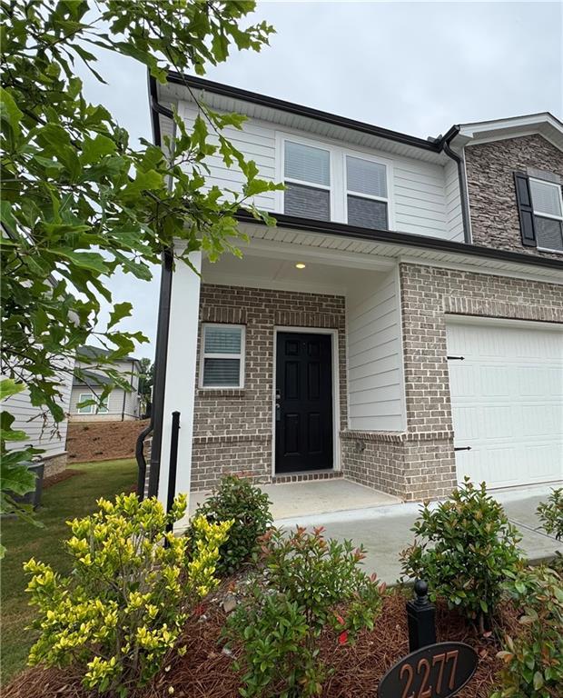 2277 Whitworth St, Lawrenceville, GA 30044 - view of front facade featuring brick siding and an attached garage
