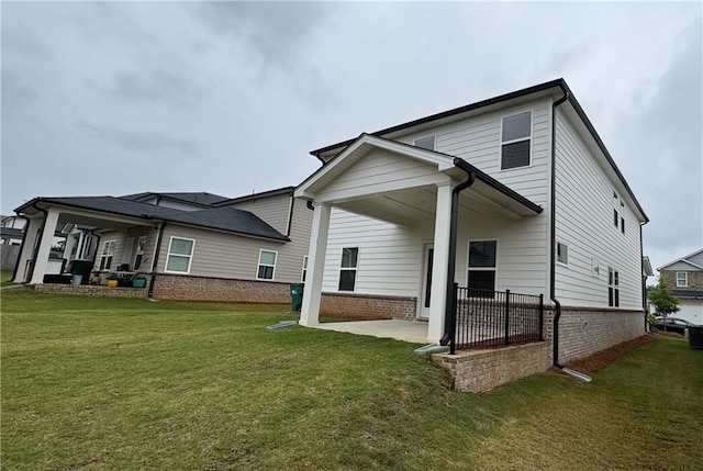 2277 Whitworth St, Lawrenceville, GA 30044 - rear view of house with a patio area, a yard, and brick siding