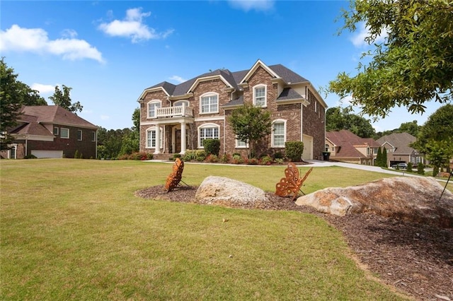 view of front of house featuring a balcony and a front lawn