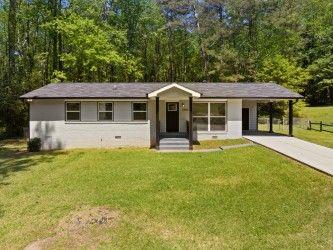2340 Cresta Dr, Decatur, GA 30032 - ranch-style house with concrete driveway and an attached carport