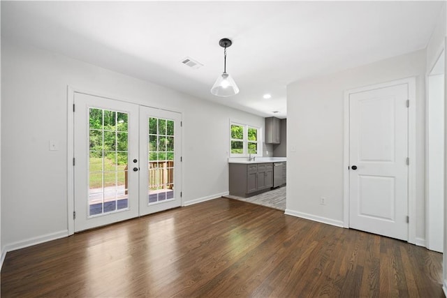 2340 Cresta Dr, Decatur, GA 30032 - unfurnished living room featuring french doors, dark wood-style flooring, and baseboards