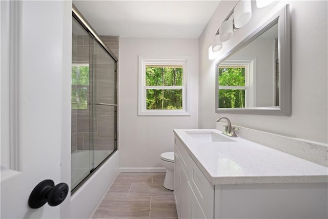 2340 Cresta Dr, Decatur, GA 30032 - full bath featuring toilet, baseboards, vanity, and enclosed tub / shower combo