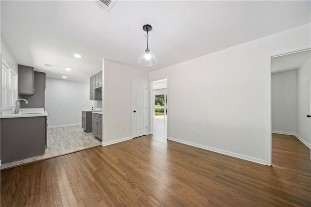 2340 Cresta Dr, Decatur, GA 30032 - unfurnished living room featuring a sink, dark wood-type flooring, baseboards, and recessed lighting