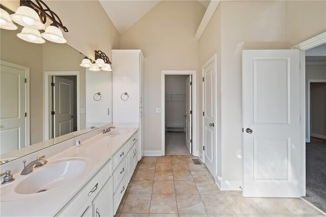403 Pebblebrooke Ln, Canton, GA 30115 - bathroom with double vanity, lofted ceiling, a spacious closet, baseboards, and a baseboard radiator