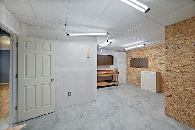 basement featuring a paneled ceiling