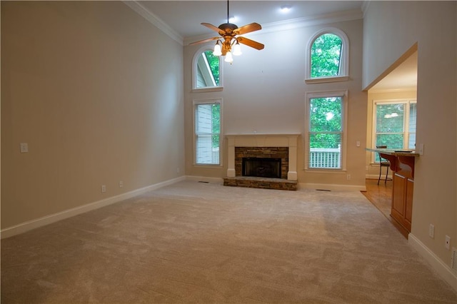 403 Pebblebrooke Ln, Canton, GA 30115 - unfurnished living room featuring crown molding, a ceiling fan, carpet floors, plenty of natural light, and a towering ceiling
