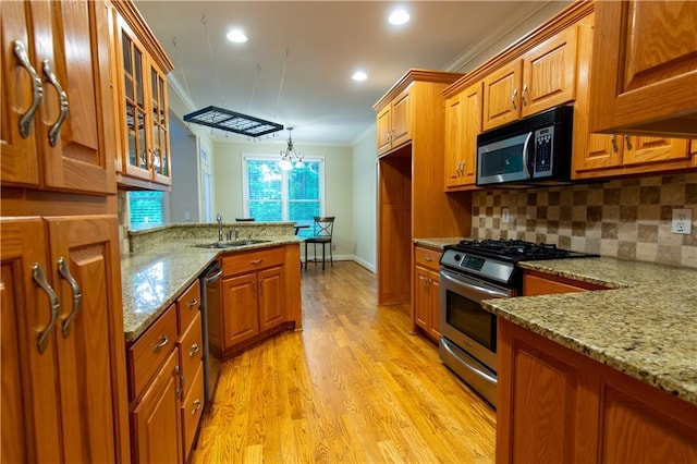 403 Pebblebrooke Ln, Canton, GA 30115 - kitchen with appliances with stainless steel finishes, a sink, ornamental molding, brown cabinetry, and tasteful backsplash