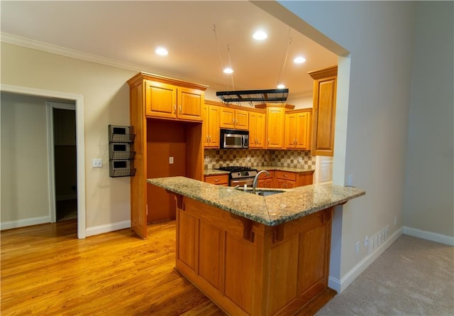 403 Pebblebrooke Ln, Canton, GA 30115 - kitchen featuring stainless steel appliances, light stone counters, brown cabinets, backsplash, and ornamental molding