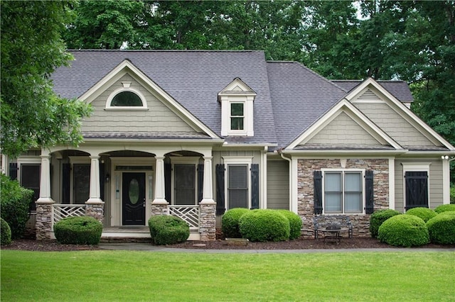 403 Pebblebrooke Ln, Canton, GA 30115 - craftsman-style home with stone siding, covered porch, a front yard, and a shingled roof