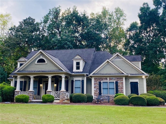 403 Pebblebrooke Ln, Canton, GA 30115 - craftsman-style home with a front yard, covered porch, stone siding, and roof with shingles