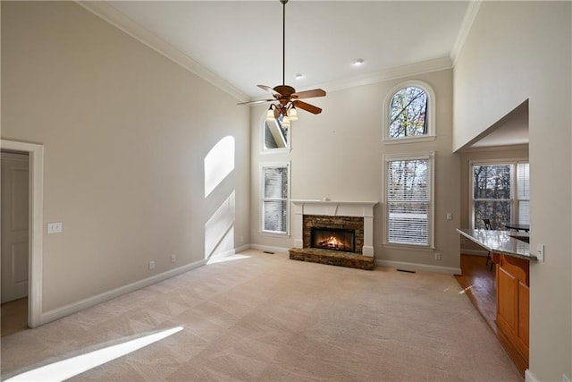403 Pebblebrooke Ln, Canton, GA 30115 - unfurnished living room with a towering ceiling, light carpet, crown molding, baseboards, and ceiling fan