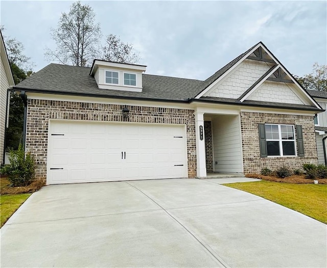 craftsman-style house featuring a front lawn and a garage