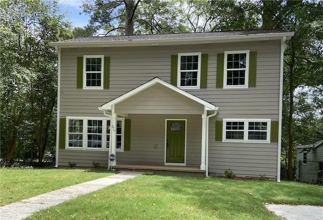 view of front of home with covered porch and a front yard