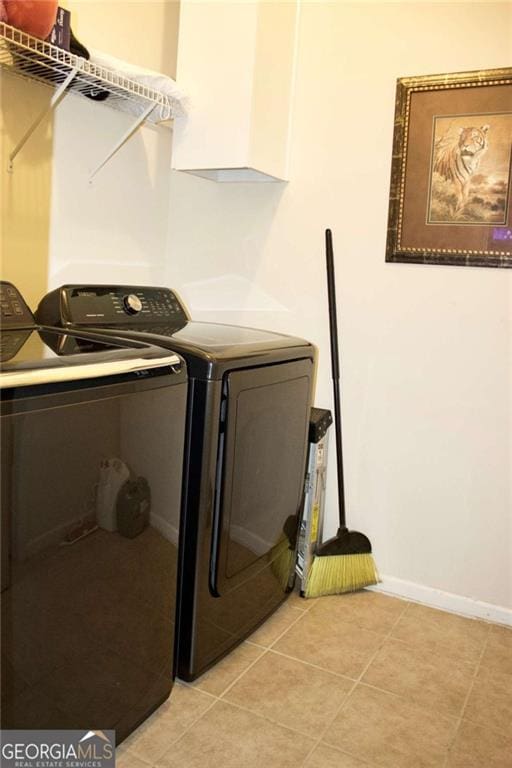 978 Francis Ln, Fairburn, GA 30213 - laundry area with washing machine and dryer and light tile patterned floors