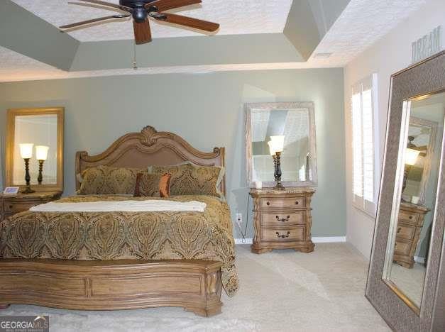 978 Francis Ln, Fairburn, GA 30213 - bedroom featuring carpet floors, multiple windows, and a ceiling fan