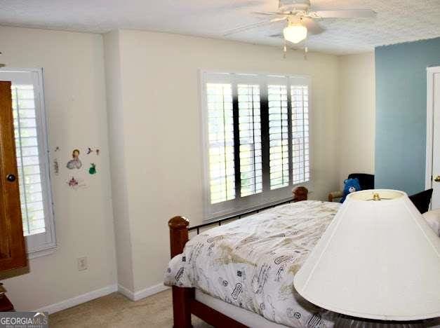 978 Francis Ln, Fairburn, GA 30213 - bedroom with multiple windows and ceiling fan