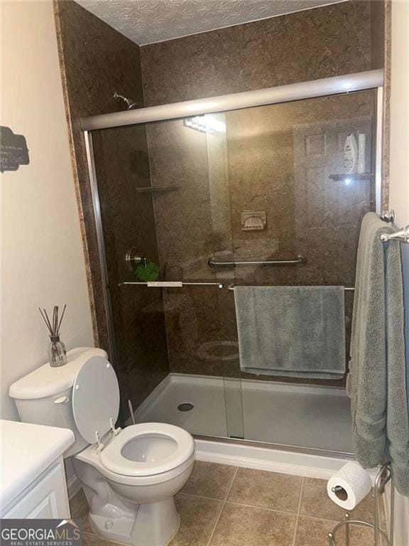 978 Francis Ln, Fairburn, GA 30213 - full bathroom featuring vanity, a stall shower, tile patterned flooring, and a textured ceiling