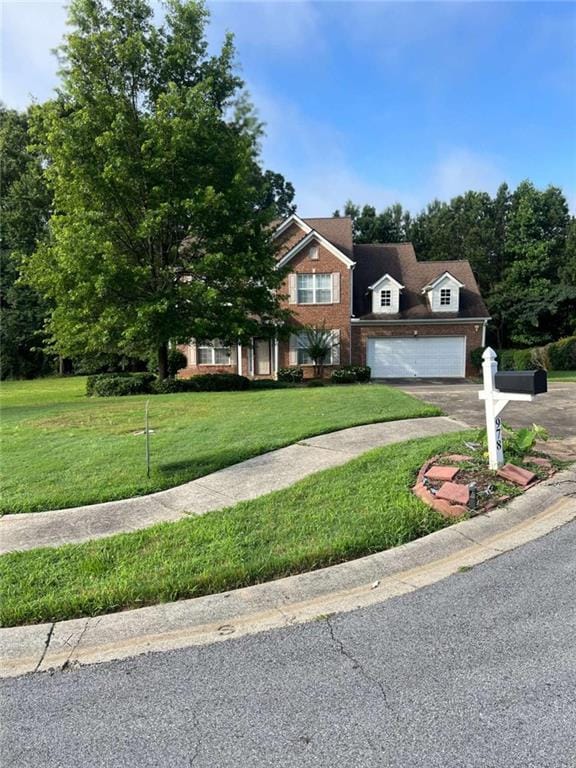 978 Francis Ln, Fairburn, GA 30213 - view of front of house with asphalt driveway, a front yard, and brick siding