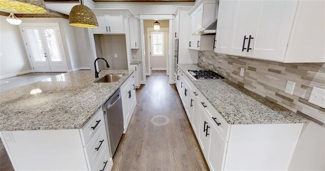 kitchen with pendant lighting, white cabinetry, sink, and stainless steel appliances