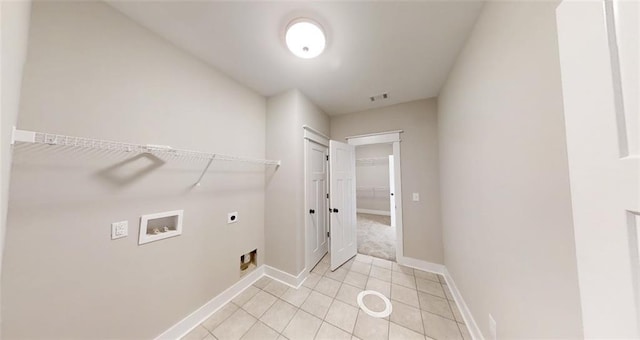 washroom featuring hookup for an electric dryer, light tile patterned floors, and hookup for a washing machine