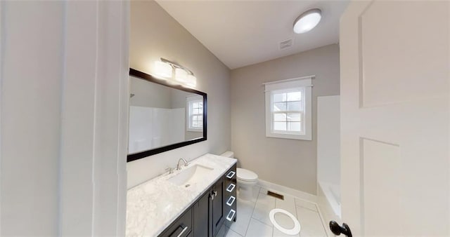 bathroom with tile patterned flooring, vanity, toilet, and walk in shower