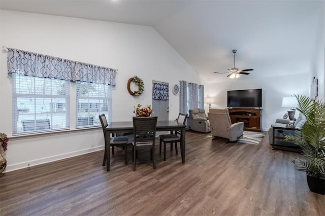 dining space featuring high vaulted ceiling, dark wood-type flooring, and ceiling fan