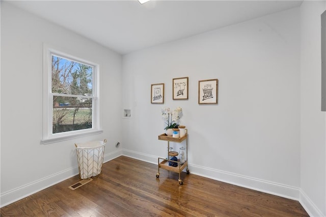 unfurnished room with wood finished floors and baseboards