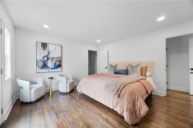 bedroom with wood finished floors, baseboards, and recessed lighting