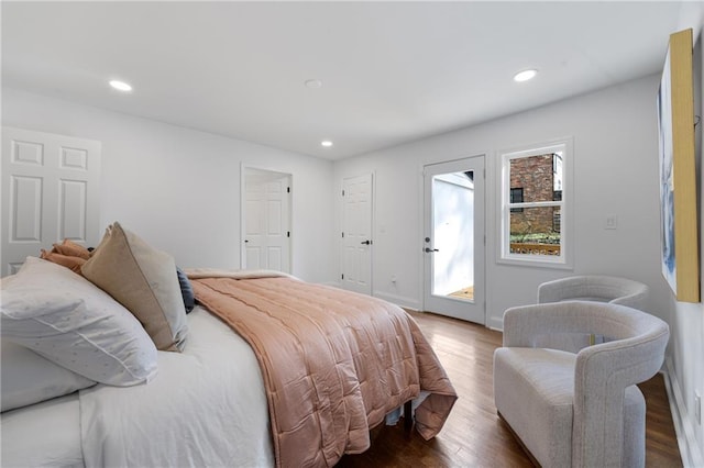 bedroom with wood finished floors, recessed lighting, and baseboards