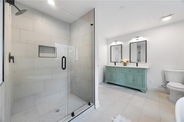 full bath featuring baseboards, toilet, a shower stall, double vanity, and tile patterned floors