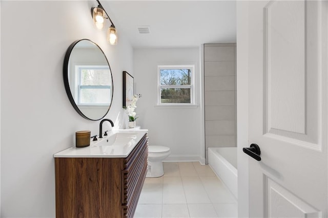 full bathroom featuring toilet, tile patterned floors, vanity, a bath, and baseboards