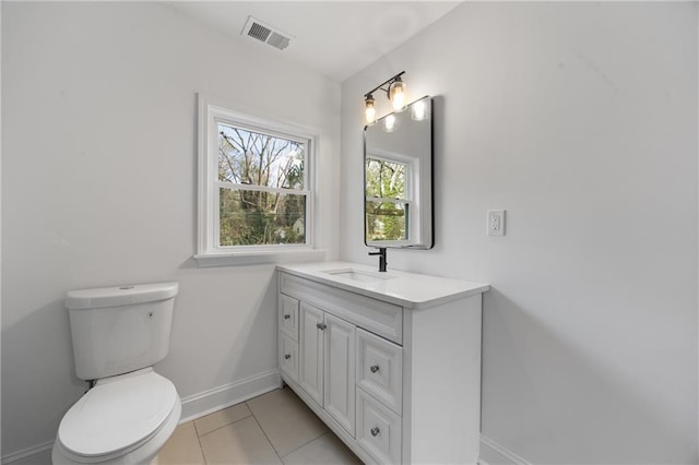 bathroom with baseboards, toilet, vanity, and tile patterned floors