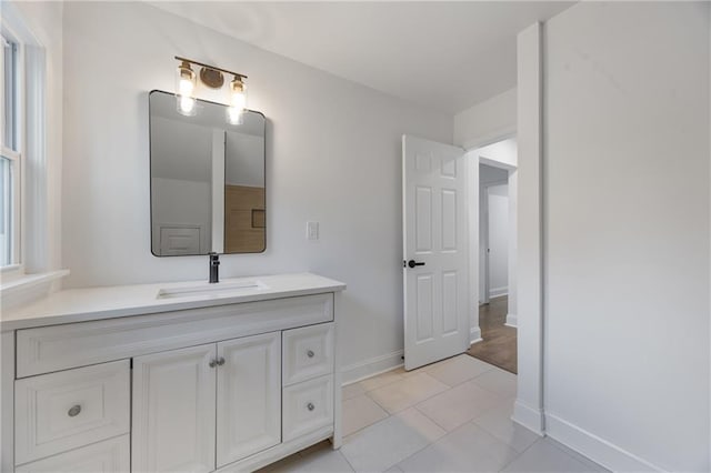 bathroom featuring baseboards, vanity, and tile patterned floors