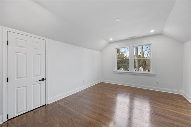 additional living space with lofted ceiling, baseboards, wood finished floors, and recessed lighting