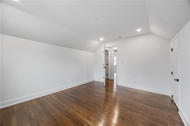additional living space with lofted ceiling, baseboards, wood finished floors, and recessed lighting