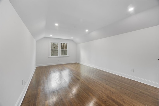 bonus room featuring vaulted ceiling, dark wood-style flooring, baseboards, and recessed lighting