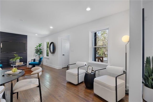 living area featuring healthy amount of natural light, wood finished floors, recessed lighting, and baseboards