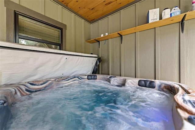 interior space featuring wooden ceiling, lofted ceiling, and a jacuzzi