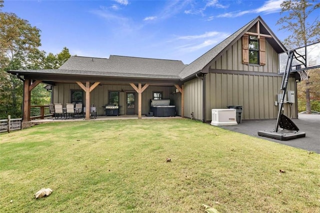 back of house with a patio and a yard