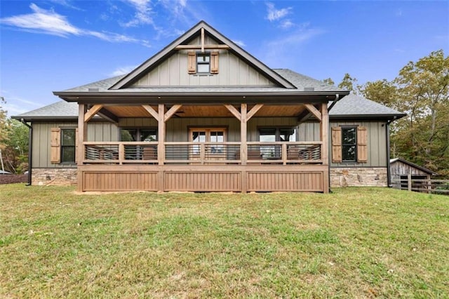 rear view of house featuring a lawn