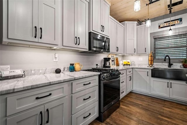 kitchen with wood ceiling, dark hardwood / wood-style floors, black gas stove, sink, and pendant lighting