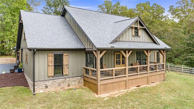 rear view of property featuring a yard