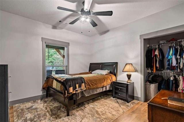 bedroom with light hardwood / wood-style flooring, a closet, and ceiling fan