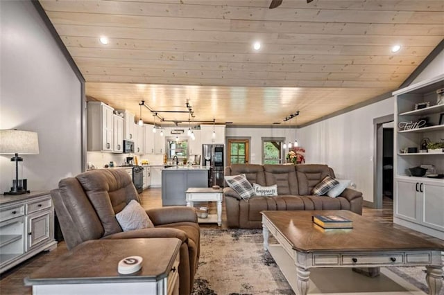 living room with track lighting, wooden ceiling, and vaulted ceiling