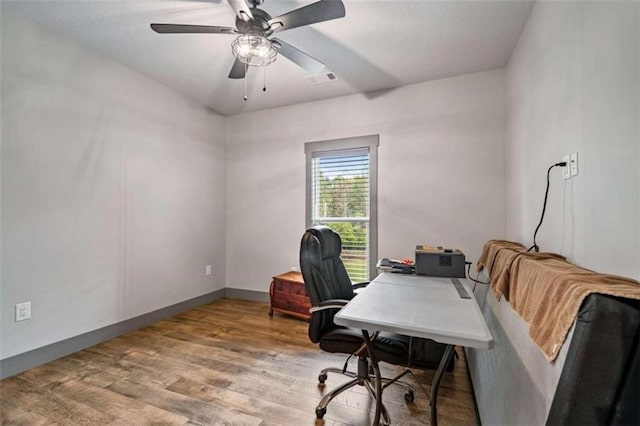 office space featuring ceiling fan and light wood-type flooring